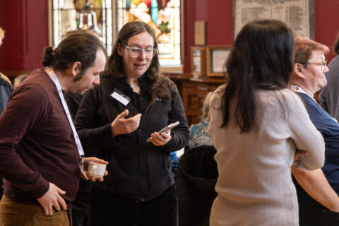 An image of members of conference interacting 