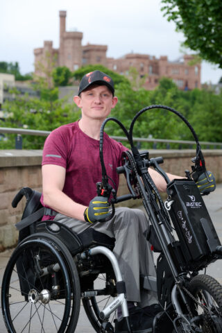 Grzegorz Faryno with his wheelchair accessoryBeside the river Ness.