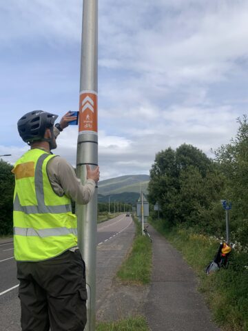 Image of staff at the side of the road working on a road pole