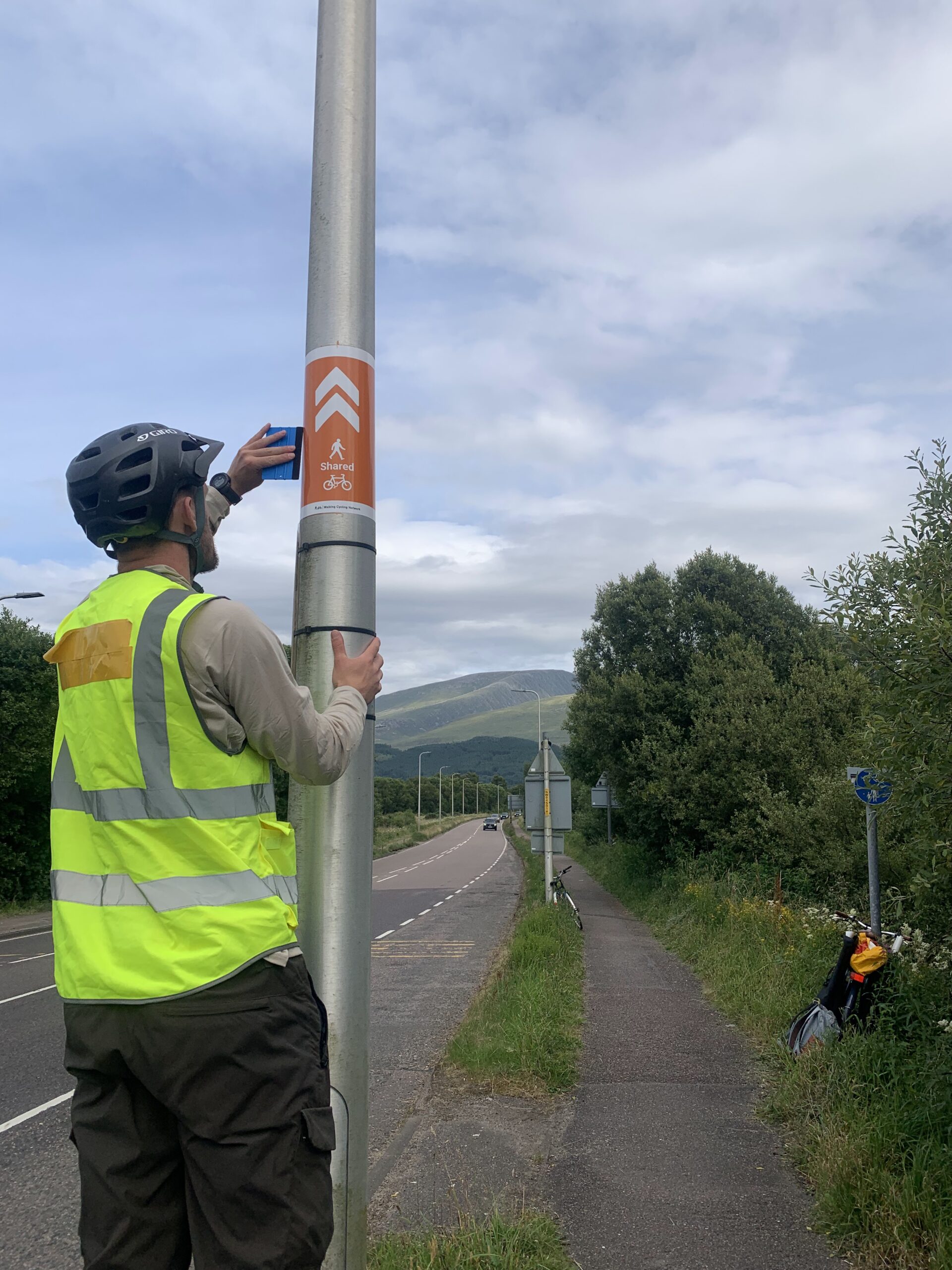 Image of staff at the side of the road working on a road pole